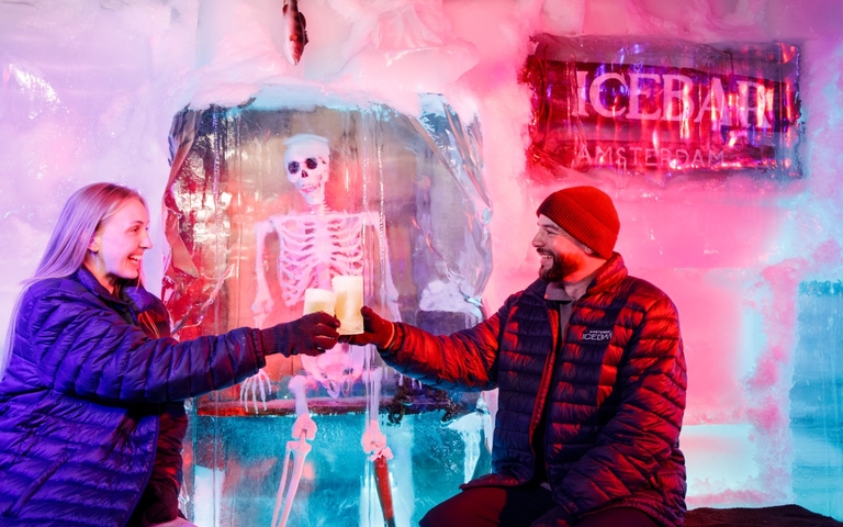Cheers with beer in glasses made of ice amsterdam icebar